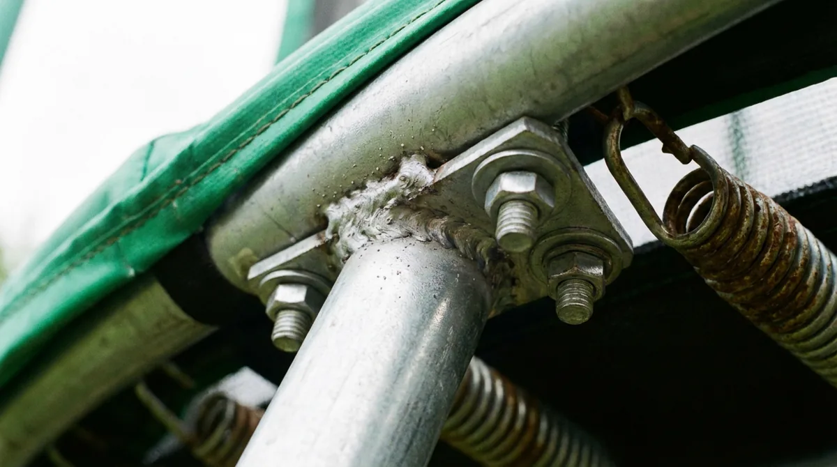 Close-up of galvanised steel frame and spring detail on a Kanga trampoline